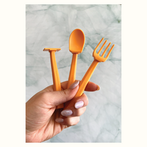 Colorful baby training utensils set for easy feeding, displayed at a 10-degree angle.