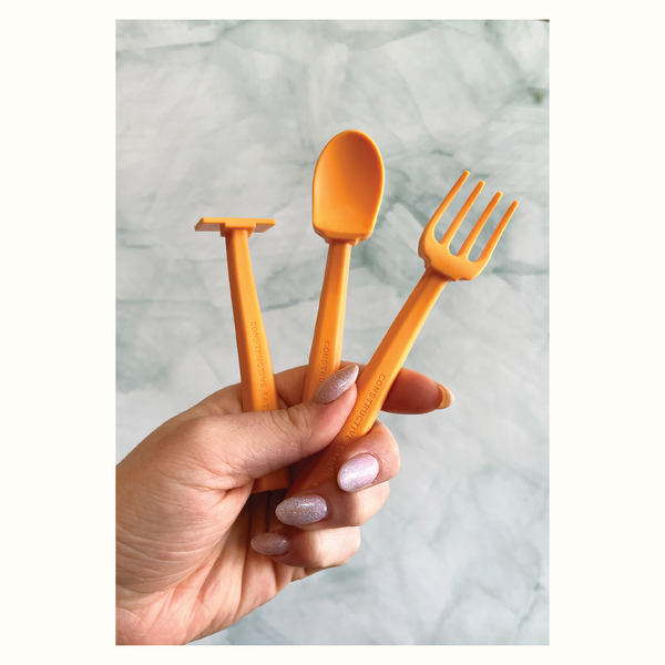 Colorful baby training utensils set for easy feeding, displayed at a 10-degree angle.