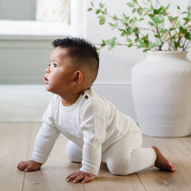 Heirloom cotton knit two-piece baby set in soft colors, perfect for comfort and style.