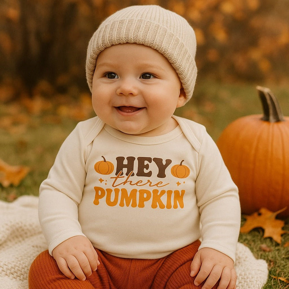 Long sleeve graphic bodysuit for babies featuring "Hey There Pumpkin" design. Perfect for fall outfits.