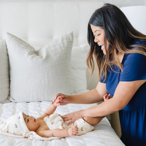 Soft baby hooded towels in pastel colors, perfect for keeping your little one warm and cozy after bath time.