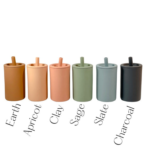Silicone straw cup for babies and toddlers in various colors, angled view showcasing design and functionality.