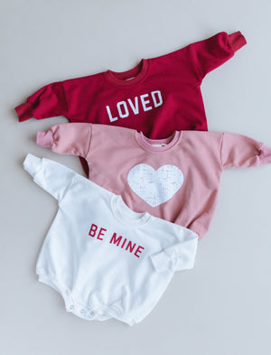 Distressed Heart Sweatshirt Romper in various colors, shown from angle 2, perfect for stylish baby outfits.