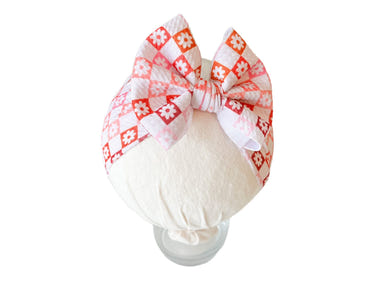 Ombre checkers and flowers headwrap bow for babies, perfect accessory for hats, socks, and mittens collection.