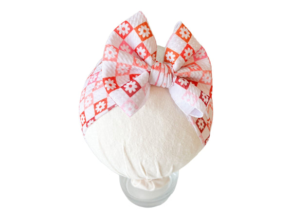 Ombre checkers and flowers headwrap bow for babies, perfect accessory for hats, socks, and mittens collection.