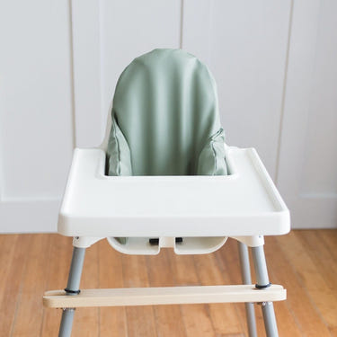 Sage green vegan leather IKEA Antilop cushion cover for baby seat, stylish and comfortable accessory.