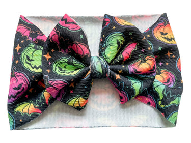 Neon Halloween Headwrap Bow for babies, perfect accessory for festive outfits and cozy swaddles.