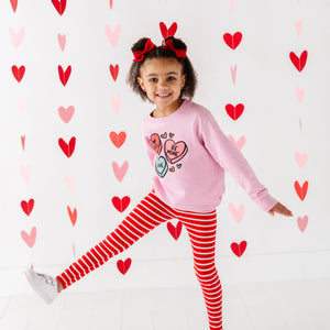 Candy Heart's cozy sweatshirt for babies, featuring a playful design, perfect for stylish comfort in any season.
