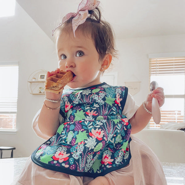 Desert Floral Bapron for babies, featuring a stylish design from angle 2, perfect for mealtime messes.