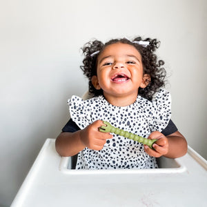 Organic Dot Flutter Bapron for babies, angled view showcasing its playful design and eco-friendly fabric.