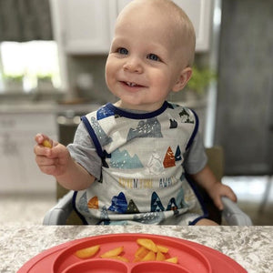 "Adventure Awaits Bapron for babies, angle view showcasing fun design and practical features for mealtime."