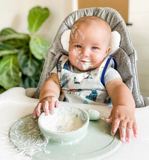 "Adventure Awaits Bapron in angle 11 view, perfect for messy mealtime fun for babies and toddlers."