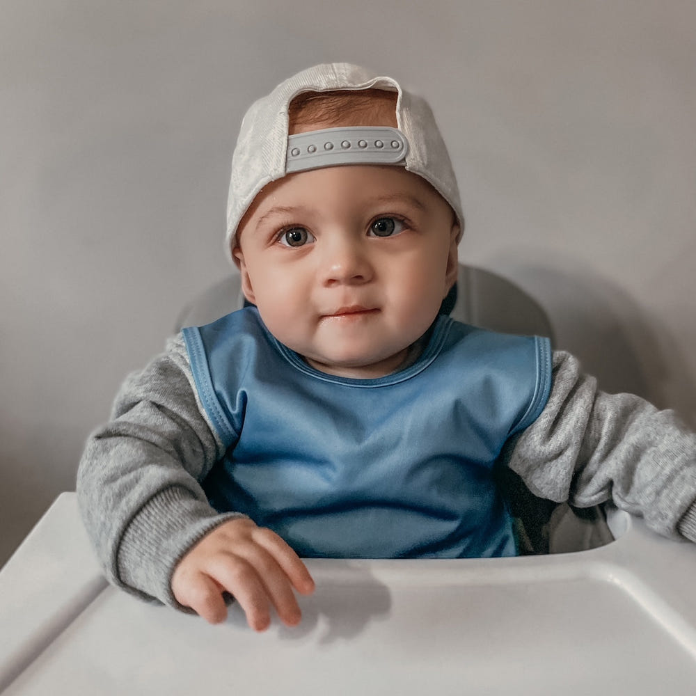 Solid dusty blue minimalist bapron for babies, perfect for mealtime messes and stylish protection.