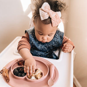 "Willow Bapron for babies, stylish and functional, shown at angle 8 for a clear view of design and fit."