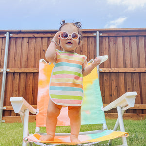 Rainbow Stripes Bapron for babies, angled view showcasing vibrant colors and practical design for mealtime messes.