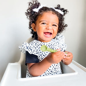 Organic Dot Flutter Bapron for babies, featuring a playful design and comfortable fit, shown at an angle.