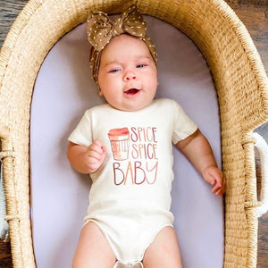 Spice Spice Baby graphic bodysuit for infants, short sleeve, playful design, angle view showcasing vibrant colors.