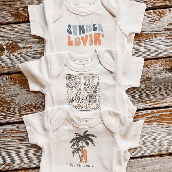 "Summer Lovin' graphic bodysuit for babies, short sleeve, angle view showcasing playful design."