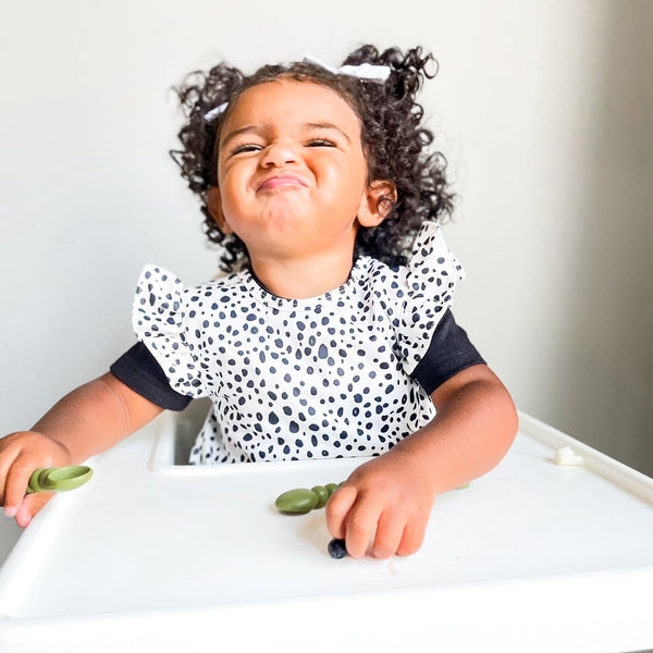 Organic Dot Flutter Bapron for babies, angled view showcasing its playful design and eco-friendly fabric.