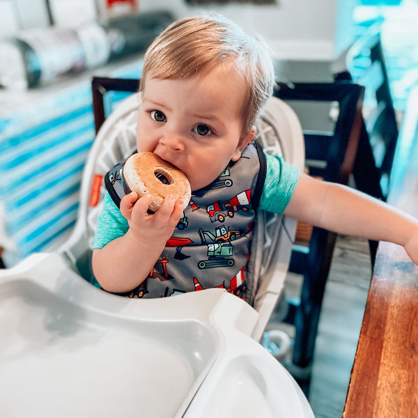 "Construction Zone Bapron for babies, featuring a fun design and practical coverage, perfect for mealtime messes."