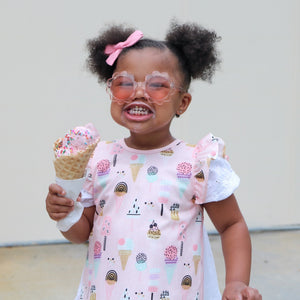 Pink Ice Cream Flutter Bapron for babies, showcasing a playful design at an angle. Perfect for mealtime messes!