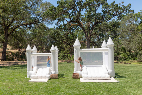 Mini Ava white bounce house with cone tops, perfect for outdoor playsets, shown from angle 4.