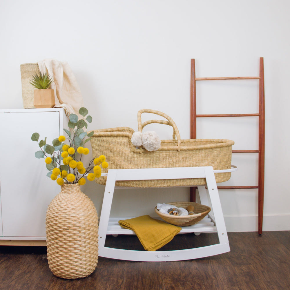 Classic white rocking Moses bassinet stand with brake, perfect for soothing your baby safely.