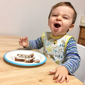 "Busy Bees Bapron for babies, angle view showcasing vibrant design and practical features for mess-free mealtime."
