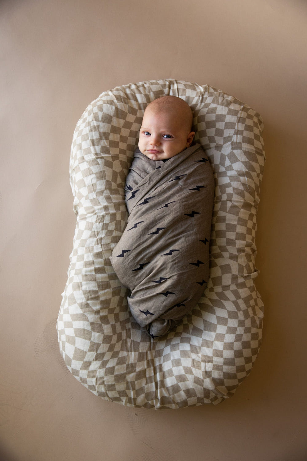 Muslin swaddle in wavy checker pattern, perfect for wrapping your baby in comfort and style.