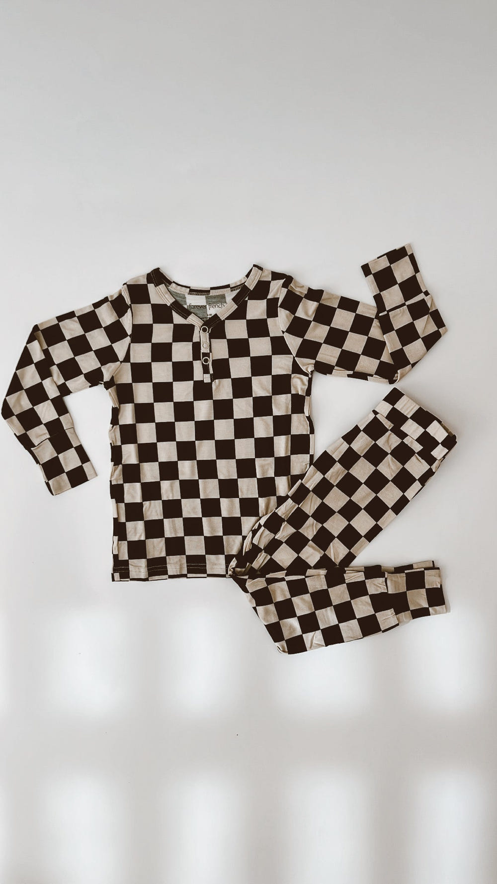 Bamboo two-piece pajamas in black checkerboard for babies, perfect for comfortable sleep.