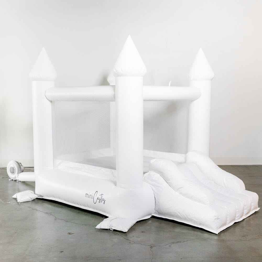 Mini Ava white bounce house with cone tops for outdoor playsets, perfect for kids' fun and active playtime.