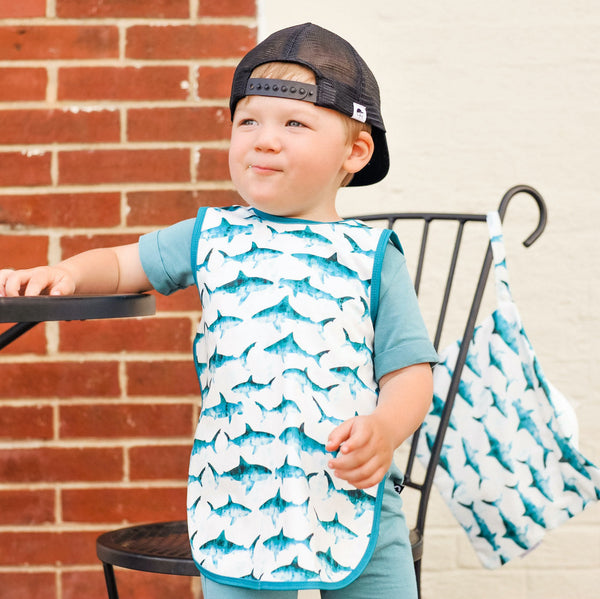 Shark Attack Bapron for babies, featuring a fun shark design, angled view showcasing its unique shape and functionality.