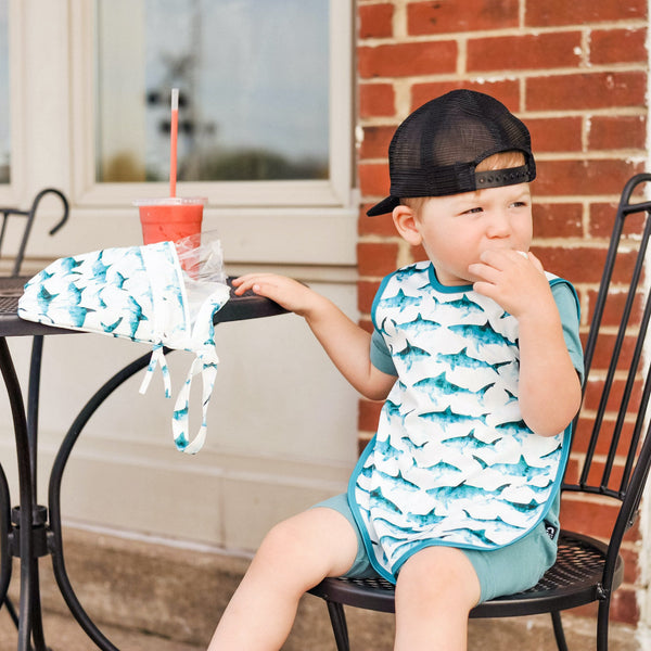 Shark Attack Bapron for babies, angled view showcasing fun design and practical use for mealtime messes.