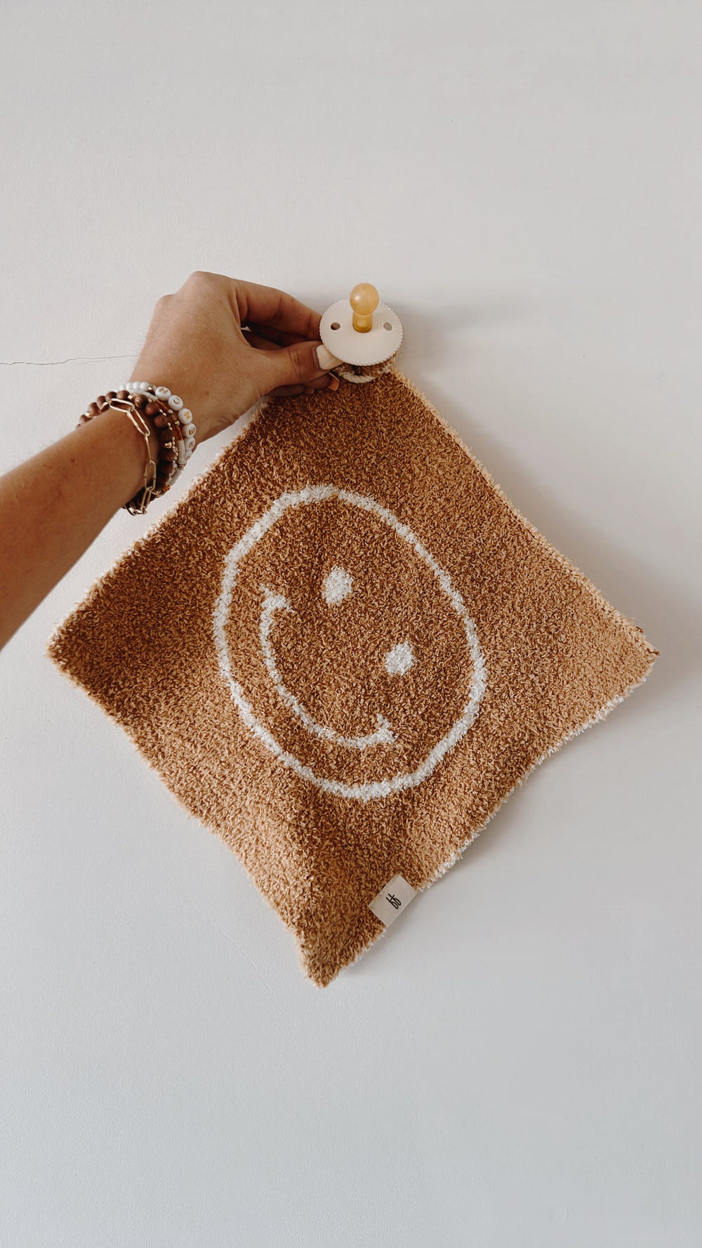 Tan Just Smile Lovey for babies, soft and cuddly comfort for your little one. Perfect for snuggles and playtime.