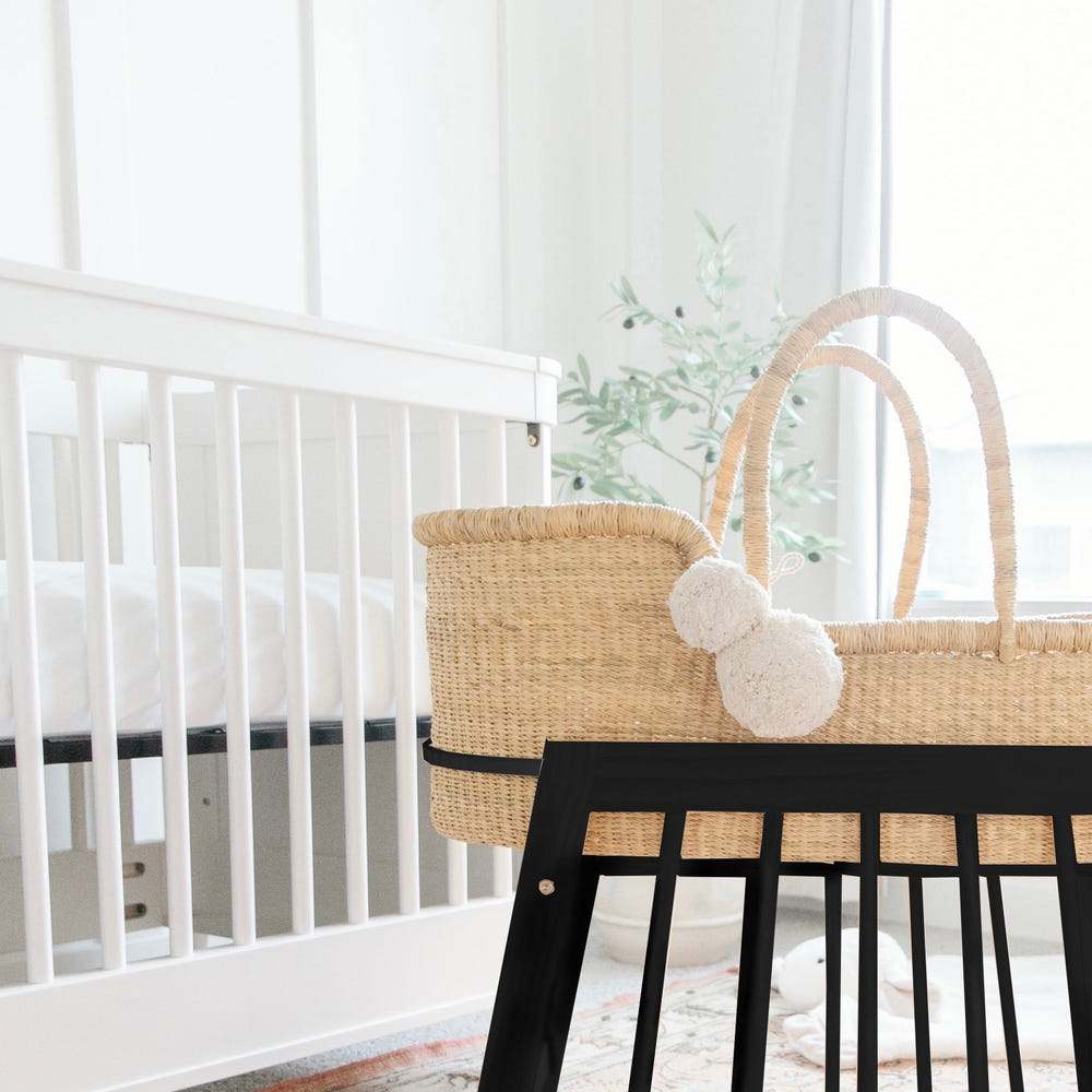 Modern black rocking Moses bassinet stand with brake, perfect for safe and stylish baby sleeping.