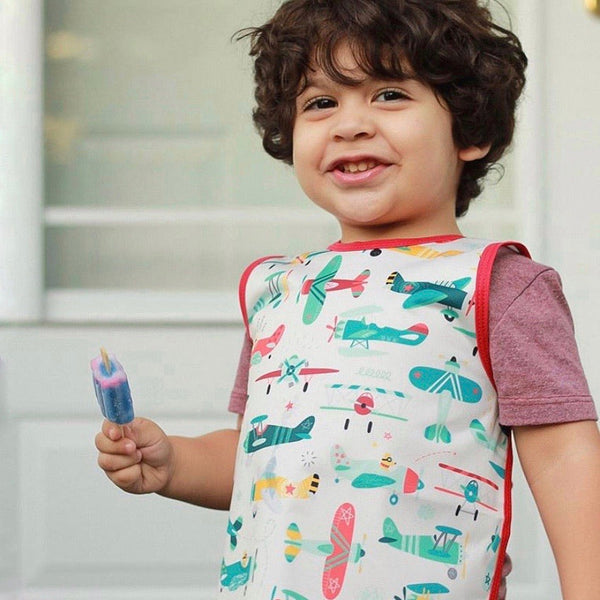 Retro Airplanes Bapron for babies, featuring a playful design, angled view showcasing its vibrant colors and unique style.
