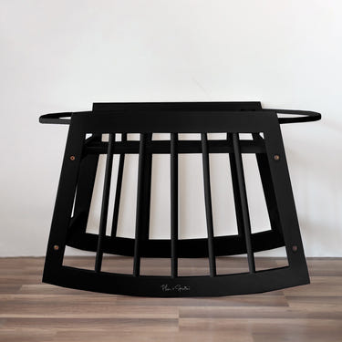 Modern black rocking Moses bassinet stand with brake, perfect for safe and stylish baby sleeping.