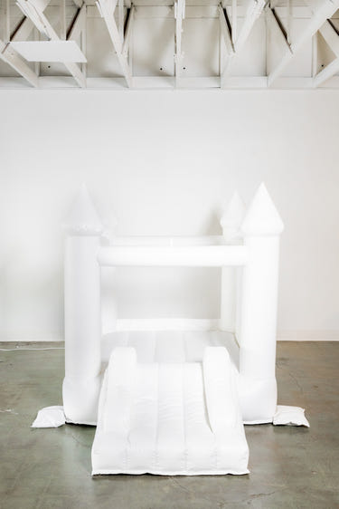 Mini Ava white bounce house with cone tops for outdoor playsets, perfect for kids' fun and active playtime.