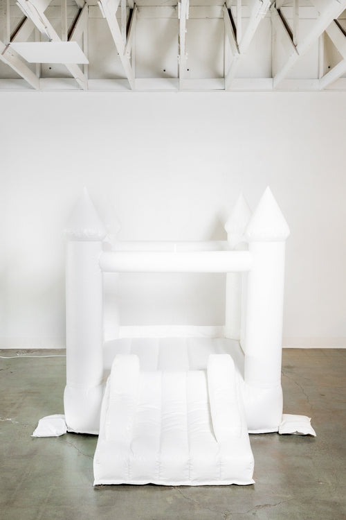 Mini Ava white bounce house with cone tops for outdoor playsets, perfect for kids' fun and active playtime.