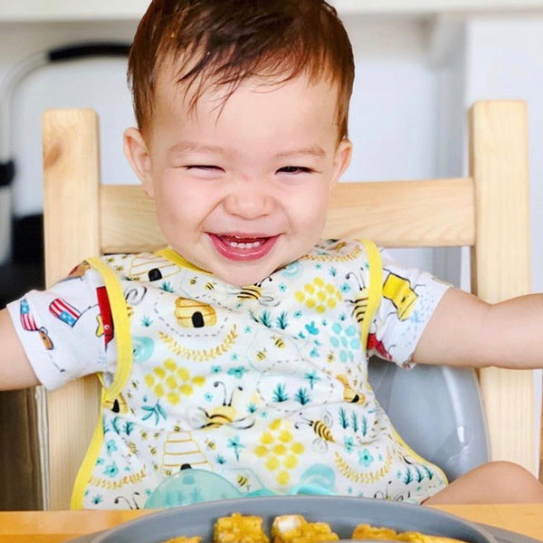 "Busy Bees Bapron for babies, featuring a colorful bee design, perfect for mess-free feeding and playtime."