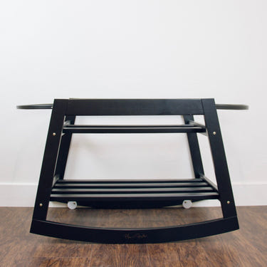 Classic black rocking Moses bassinet stand with brake, perfect for soothing your baby safely.