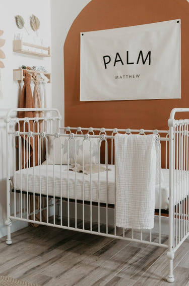 Soft cloud-patterned crib sheet for babies, perfect for swaddling and nursery decor.