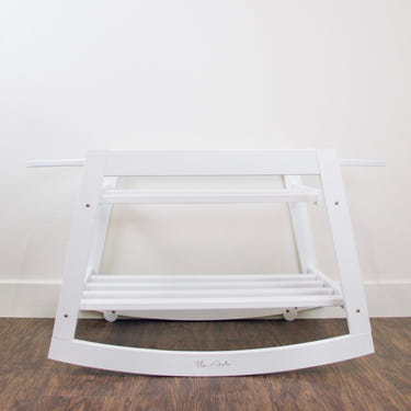 Classic white rocking Moses bassinet stand with brake, perfect for soothing your baby safely.