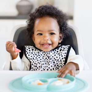 Organic Dot Bapron for babies, angle view showcasing its stylish design and eco-friendly fabric.