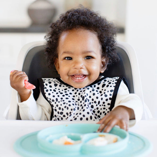 Organic Dot Bapron for babies, angle view showcasing its stylish design and eco-friendly fabric.