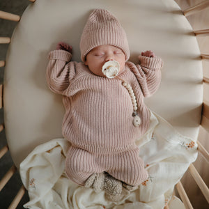 Chunky knit baby pants in a cozy design, displayed at an angle for a stylish look. Perfect for little ones!