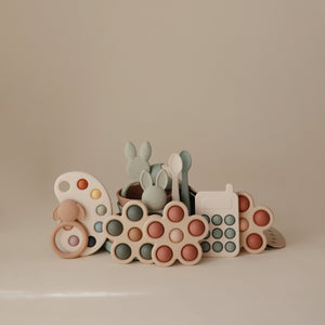 Colorful flower press toy for babies, designed to stimulate creativity and fine motor skills. Angle view 23.