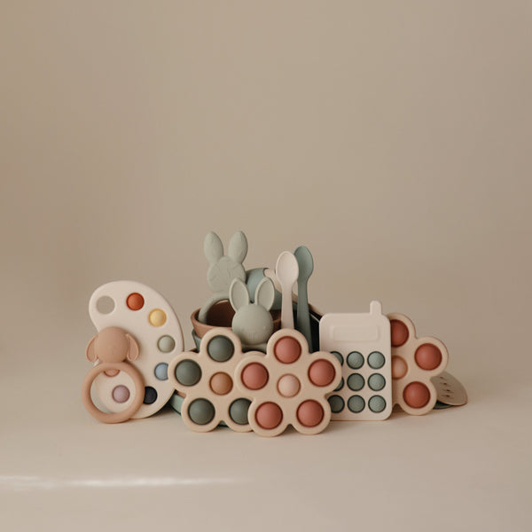 Colorful flower press toy for babies, designed to stimulate creativity and fine motor skills. Angle view 23.