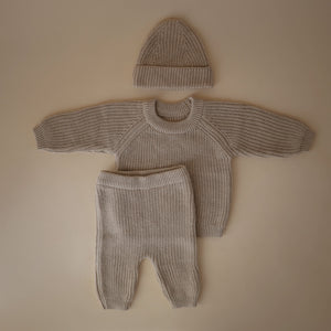 Chunky knit pants for babies in a cozy design, showcasing a stylish angle view. Perfect for comfort and warmth.
