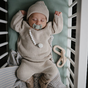 Chunky knit pants for babies, cozy and stylish, shown from a 15-degree angle. Perfect for comfort and warmth.
